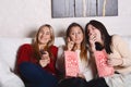 Three young friends eating popcorn and watching movies. Royalty Free Stock Photo