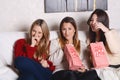 Three young friends eating popcorn and watching movies. Royalty Free Stock Photo