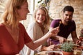 Three young friends having fun eating tapas at a restaurant Royalty Free Stock Photo