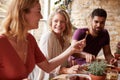 Three young friends having fun eating tapas at a restaurant