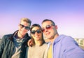 Three young friends taking selfie on sunny autumn day