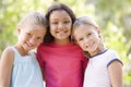 Three young girl friends standing outdoors smiling Royalty Free Stock Photo