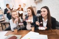 Three young girls eating sweet cake at lunchtime in office. Lunch break.