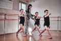 Three young girls have a ballet training with their attractive teacher Royalty Free Stock Photo