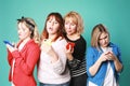 Three young girls and one adult woman and smart phone Royalty Free Stock Photo