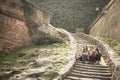 Three young girls sitting on the stairs at the public park. Royalty Free Stock Photo