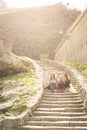 Three young girls sitting on the stairs at the public park. Royalty Free Stock Photo