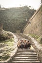 Three young girls sitting on the stairs at the public park. Royalty Free Stock Photo