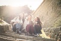 Three young girls sitting on the stairs at the public park. Royalty Free Stock Photo