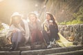 Three young girls sitting on the stairs at the public park. Royalty Free Stock Photo