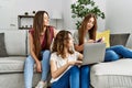 Three young hispanic woman smiling happy using laptop and credit card sitting on the sofa at home Royalty Free Stock Photo