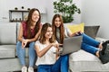 Three young hispanic woman smiling happy using laptop sitting on the sofa at home Royalty Free Stock Photo