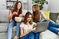 Three young hispanic woman smiling happy watching film using laptop at home Royalty Free Stock Photo