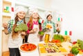 Three young Italian cooks at the kitchen Royalty Free Stock Photo