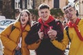 Three young Italian students having fun on a school trip and posing for the camera in Trastevere