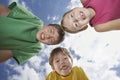 Three Young Kids Bending Down Against Sky Royalty Free Stock Photo