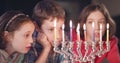 Kids watching hanukka candles burning