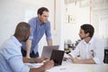 Three young men discussing business at an office meeting Royalty Free Stock Photo