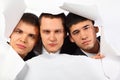 Three young men looking out in hole in paper Royalty Free Stock Photo