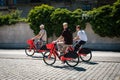 Three young men riding ebikes or. electric bikes of bicycle sharing service JUMP by UBER