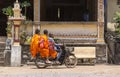Three young monks riding a motorbike