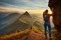 Three young non recognizable trekking women with backpacks standing on top of mountain at sunset and enjoying view. AI