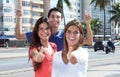 Three young people in the city showing thumb up Royalty Free Stock Photo