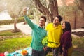 Three young people make selfi under the olive tree Royalty Free Stock Photo