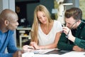 Multi-ethnic group of three young people studying together Royalty Free Stock Photo