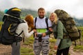 Three young people of tourists friends a guy and two girls blond Royalty Free Stock Photo