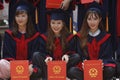 Three young students with their diploma