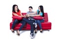 Three young teenagers fighting for remote control Royalty Free Stock Photo