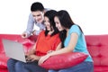 Three young teenagers looking at the laptop Royalty Free Stock Photo