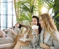 Three young women drinking tea at spa resort Royalty Free Stock Photo