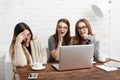 Three young women friends with laptop. Royalty Free Stock Photo