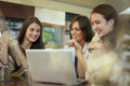 Three young women having conversation in cafe. Royalty Free Stock Photo