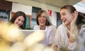 Three young women having conversation in cafe. Royalty Free Stock Photo