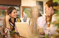 Three young women having conversation in cafe. Royalty Free Stock Photo