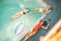 Three young women relaxing in the swimming pool Royalty Free Stock Photo