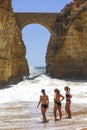 Three young women standing in the water at the beach in Lagos, Portugal.