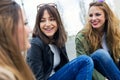 Three young women talking and laughing in the street. Royalty Free Stock Photo