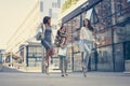 Three young women walking street after good shopping. Royalty Free Stock Photo