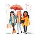 Three young women walking under one umbrella during autumn rain. Diverse female friends