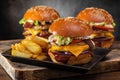 Three yummy grilled burger with double meat cutlet and fries on a wooden table, side view.