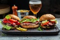 Three yummy juicy hamburgers with double cutlet and cheese. Grilled meat burger with beer. Big burger, american fast food. banner