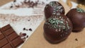 Three yummy vegan candies covered with chocolate and coconut shavings.