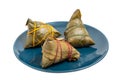 Three ZhongZi - traditional Chinese rice dish in bamboo leaves Royalty Free Stock Photo