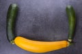 Three zucchini on kitchen table, two green, one yellow Royalty Free Stock Photo