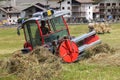 Threshing tractor in action in Cogne on the Sant\'Orso meadow..July 29,2023.