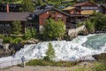 Thrill seekers zip line over the raging waters of the Bovra River located in the center of Lom during a summer afternoon